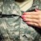 Meredith Shumrick, an Ohio University Army ROTC candidate, puts on her Class A uniform while getting ready for school.